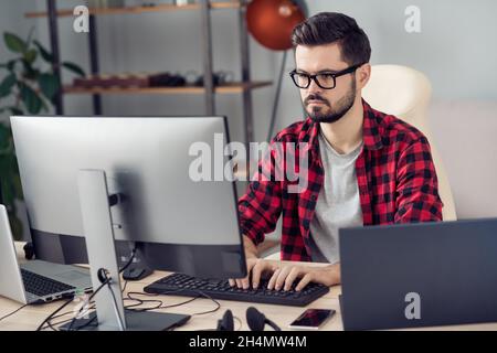 Portrait of attractive experienced focused guy writing creating code security database development at office work place station indoor Stock Photo