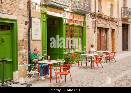 Man sitting outside a cafe / bar with a glass of beer in the Spanish town of Puente la Reina Navarra Spain part  of the Camino de Santiago de Santiago Stock Photo