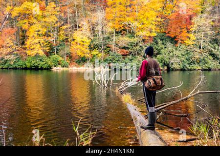 Fisherman at Balsam Lake in autumn - Roy Taylor Forest in the Nantahala National Forest, Canada, North Carolina, USA Stock Photo