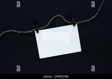 Black Friday text. Black background white sheet on clothespins and rope. Conceptual business minimalism. The concept of sales, promotions, discounts, Stock Photo