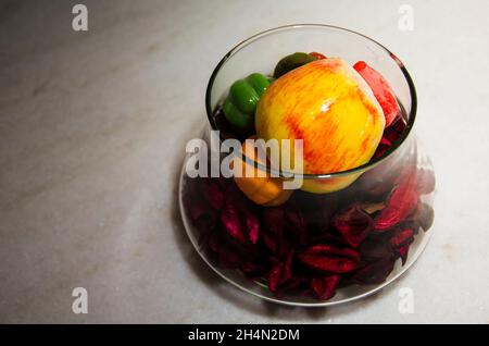 Decorative objects made of glass, plastic and wood in the interior of an apartment in different colors. Salvador, Bahia, Brazil. Stock Photo