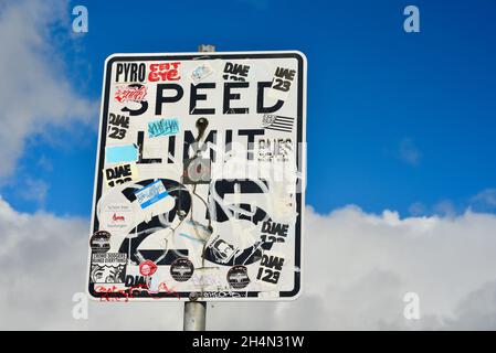Graffiti, bumper stickers and other stickers covering Speed Limit