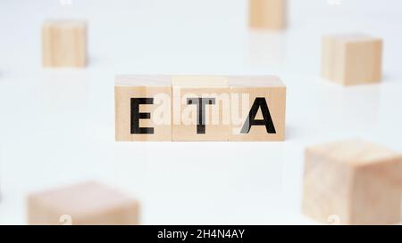 Business acronym ETA or Estimated Time of Arrival on wooden blocks Stock Photo