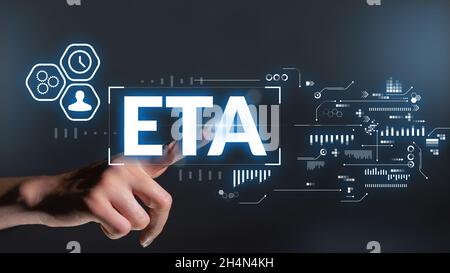 Business acronym ETA or Estimated Time of Arrival. Hand touches the display. Stock Photo