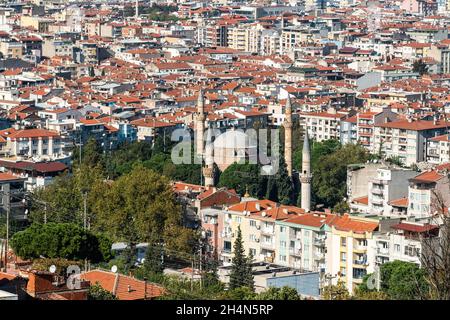 Manisa, Turkey – November 8, 2020. Aerial view over downtown Manisa, with minarets of Muradiye mosque and Hafsa Sultan mosque. Stock Photo