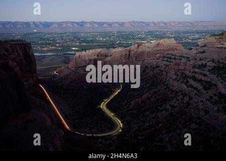 Car light trails along the canyon road at night Stock Photo