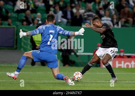 Lisbon, Portugal. 3rd Nov, 2021. Cyle Larin (R) of Besiktas vies with Sporting's goalkeeper Antonio Adan during the UEFA Champions League group C match between Sporting CP and Besiktas JK at the Jose Alvalade stadium in Lisbon, Portugal, on Nov. 3, 2021. Credit: Pedro Fiuza/Xinhua/Alamy Live News Stock Photo