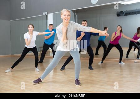 Mature woman practicing vigorous dance Stock Photo