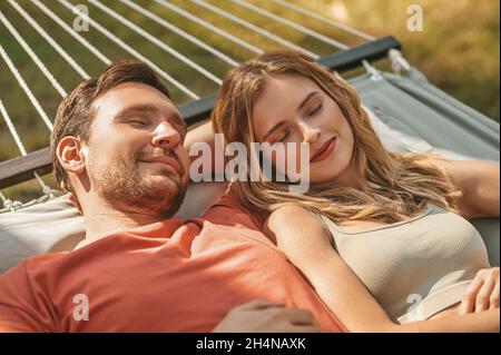 Man and woman napping in afternoon on hammock Stock Photo