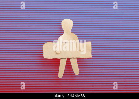 Paper man shape holding burnt note paper in hand Stock Photo