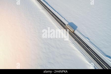 Truck carry cargo on winter snow landscape aerial drone view Stock Photo