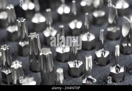 Macro shot mechanics tool set texture background.  Macro shot mechanics tool kit pattern. Set of working tools and bits. Screwdriver metal bits. Head Stock Photo