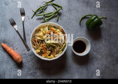 View from top of stir fried noodles or hakka chowmein served in a bowl. Stock Photo