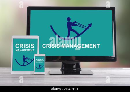 Crisis management concept shown on different information technology devices Stock Photo