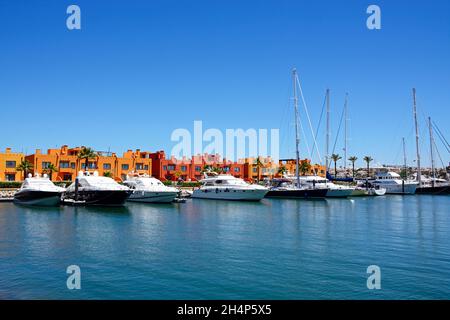 Luxury yachts and motorboats moored in the marina with apartments to the rear, Portimao, Algarve, Portugal, Europe. Stock Photo