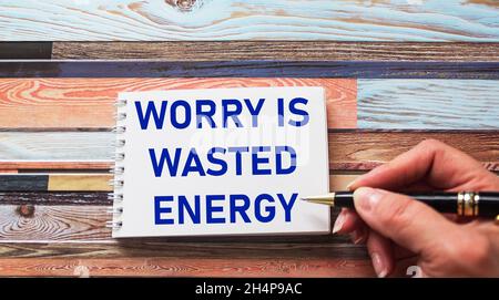 Worry is wasted energy- an inspirational quote in a notebook written in a woman's hand, a positive attitude and a concept of optimism Stock Photo