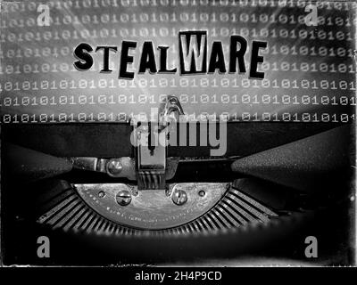 Stealware displayed on a vintage typewriter with a binary code background Stock Photo