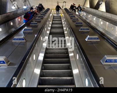 The up and down escalators in the shiny. renovated Westminster Tube station in London, England. Established in 1863 as the Metropolitan Railway, the L Stock Photo