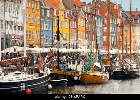 Nyhavn is a clebrated17th-century waterfront, canal and entertainment district in Copenhagen, Denmark.Lined by brightly coloured 17th and early 18th c Stock Photo