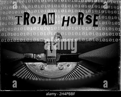 Trojan Horse displayed on a vintage typewriter with a binary code background Stock Photo