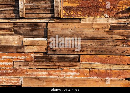 Vintage background from old rough wooden boards. Grunge texture of an old fence made of natural wooden bars and boards. Old wood fence background Stock Photo