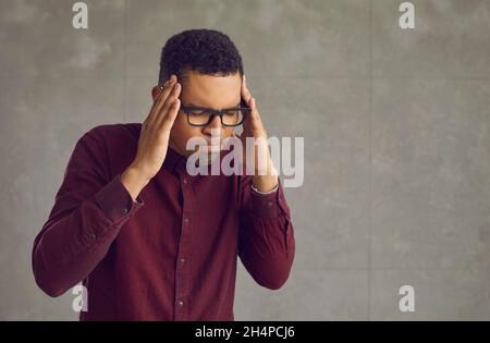 Annoyed stressed tired black man trying to calm down isolated on copy space background Stock Photo