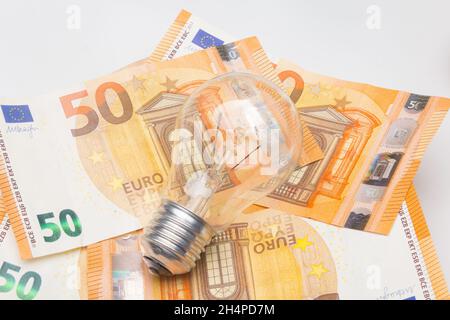 Banknotes and light bulbs on top of the money Stock Photo