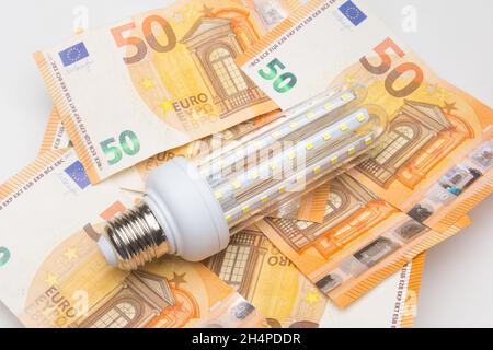Banknotes and light bulbs on top of the money Stock Photo