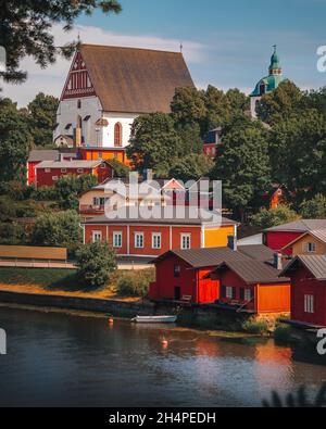 Old town of Porvoo in Finland. Colorful wooden houses on a slope near river. Stone church on a hill. Finnish architecture. Scandinavia. Riverside. Stock Photo