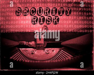 Security Risk displayed on a vintage typewriter with a binary code background Stock Photo