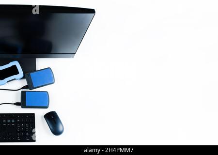 Multiple external hard drives connected to a monoblock on a white background.Computer with hard drive. Stock Photo
