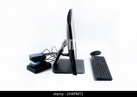 Multiple external hard drives connected to a monoblock on a white background.Computer with hard drive. Stock Photo