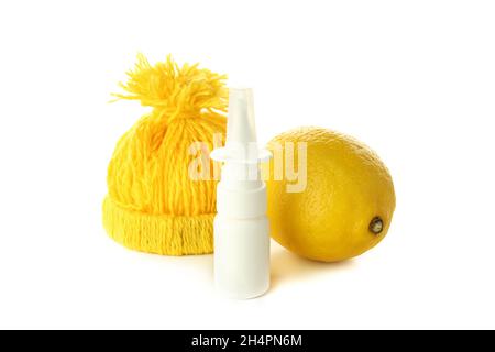 Nasal spray, lemon and knitted hat isolated on white background Stock Photo