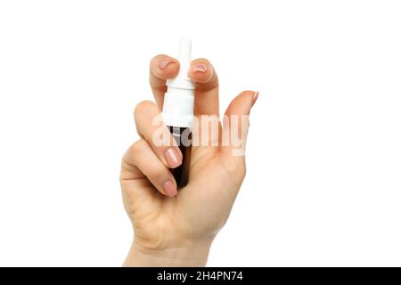 Female hand holds blank bottle of nasal spray, isolated on white background Stock Photo