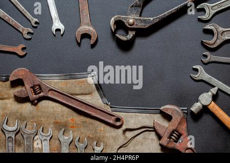 Vintage old tools on stone backdrop. Top view with copy space. Flat lay. Old rusty tools closeup. Old tools in the workshop. Stock Photo
