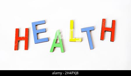 The word HEALTHY is written in color letters and a white background. Concept, spirit, body and mind, Stock Photo