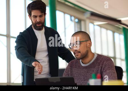 Two diverse businessmen working together on a digital tablet Stock Photo