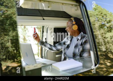 Smiling black woman having video call on smartphone Stock Photo
