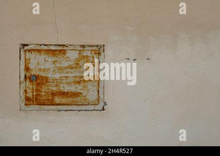 Close-up of the rusty box of a gas meter on the wall of an old building, Italy Stock Photo