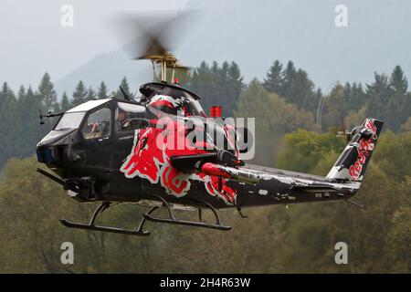 NIEDEROEBLARN, AUSTRIA - Sep 18, 2014: Flying Bulls Bell Ah-1 Cobra helicopter taking off in Niederoeblarn Stock Photo