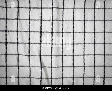 Checkered tablecloth fabric or towel. Black with white square pattern as background Stock Photo