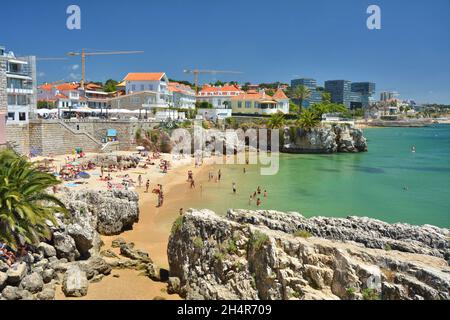 Cascais, Portugal - July 4, 2021: Tourists at the beach Praia da Rainha in Cascais, Portugal. Stock Photo