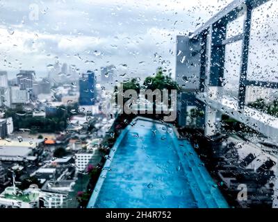 city through windows in raindrops Stock Photo