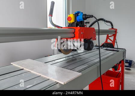 Cutter machine for ceramic tiles. A flat during renovation. Stock Photo