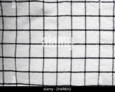 Checkered tablecloth fabric or towel. Black with white square pattern as background Stock Photo