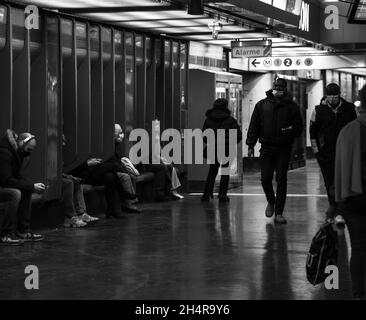 PARIS, FRANCE - NOVEMBER 1, 2021: People wearing protective masks waiting for a train of RER A line at Nation station. Social distance and protection Stock Photo