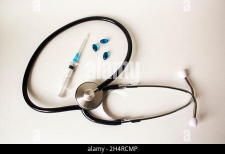 Stethoscope of various pills and injections on a white background. Medicine concept. Stock Photo