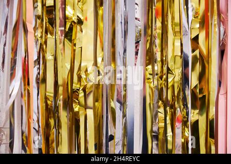 Abstract background with many colorful foil ribbons. Festive decorations and materials Stock Photo
