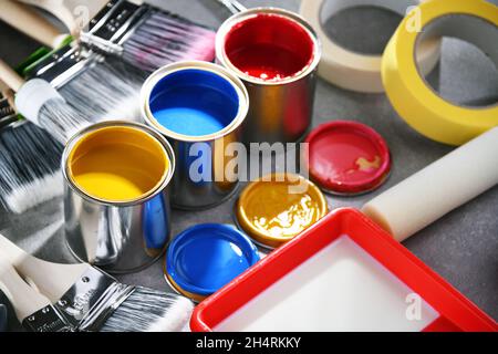 Paint cans and paintbrushes of different size  for home decorating purposes. Stock Photo