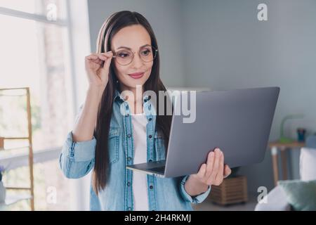 Photo of cheerful positive happy mature woman look computer smile read email indoors inside house home Stock Photo